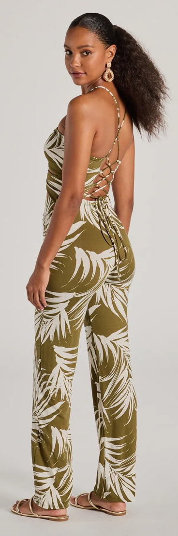 The Jet-Set to Paradise Strappy Cutout Tropical Knit Jumpsuit in olive is a versatile women's jumpsuit with trendy design accents, crafted for holiday-ready looks, from office wear to sophisticated winter night outs.