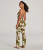 The Jet-Set to Paradise Strappy Cutout Tropical Knit Jumpsuit in olive is a versatile women's jumpsuit with trendy design accents, crafted for holiday-ready looks, from office wear to sophisticated winter night outs.