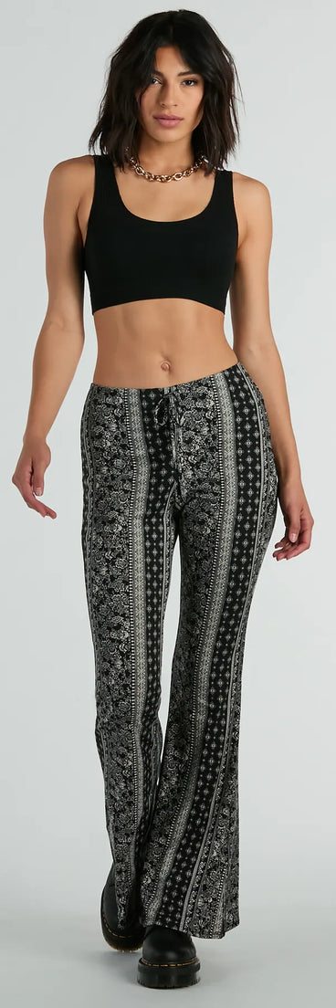 The To The Sky Boho V-Waist Tie Flare Pants in black is a pair of women's pants with an on-trend leg style and elevated fabric that adds texture, perfect for crafting effortless winter outfits.