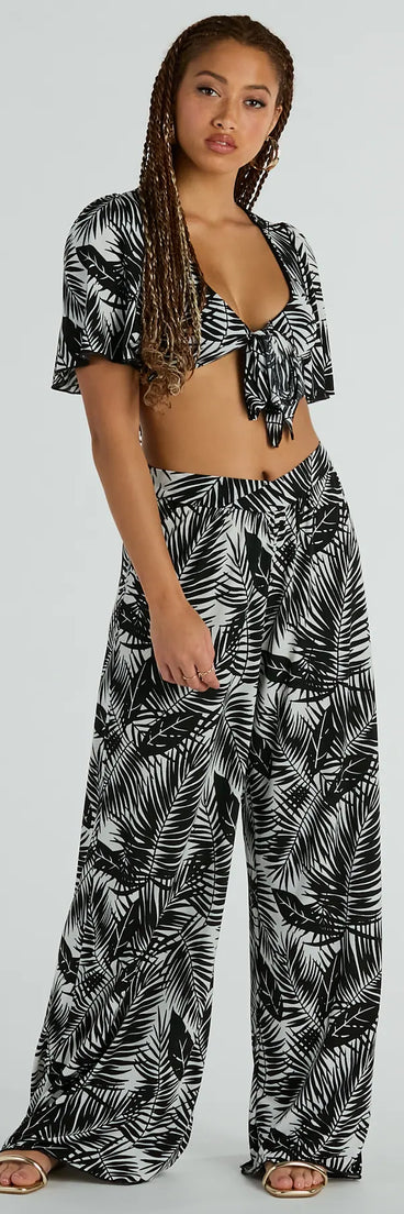 The Time For Vacay High Rise Tropical Palazzo Pants in black is a pair of women's pants with an on-trend leg style and elevated fabric that adds texture, perfect for crafting effortless winter outfits.