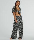 The Time For Vacay High Rise Tropical Palazzo Pants in black is a pair of women's pants with an on-trend leg style and elevated fabric that adds texture, perfect for crafting effortless winter outfits.
