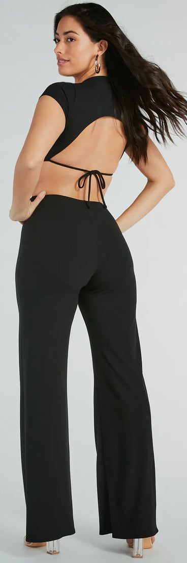 The Tie Me Right Cutout Open Back Flare Jumpsuit in black is a versatile women's jumpsuit with trendy design accents, crafted for holiday-ready looks, from office wear to sophisticated winter night outs.