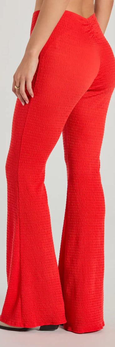 The Looking Good V-Waist Smocked Flare Pants is a trendy women's bottom in red, designed with modern details and alluring textures to complete chic outfits for 2025.