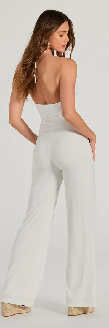 The Sultry Style Halter Cutout Wide-Leg Jumpsuit is a trendy women's bottom in ivory, designed with modern details and alluring textures to complete chic outfits for 2025.