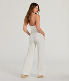 The Sultry Style Halter Cutout Wide-Leg Jumpsuit is a trendy women's bottom in ivory, designed with modern details and alluring textures to complete chic outfits for 2025.
