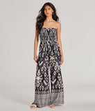 The Trendy Ease Strapless Boho Print Wide-Leg Jumpsuit in black is a women's jumpsuit with an on-trend leg style and elevated fabric that adds texture, perfect for crafting effortless winter outfits.