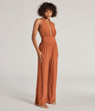 Create bold, fashion-forward looks for spring or summer with the Raise The Bar Wide-Leg Jumpsuit in rust, a must-have piece from Windsor’s collection of stylish bottoms for women.