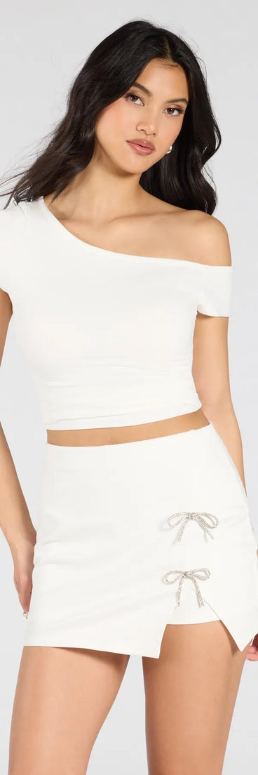 The Exceptionally Precious Rhinestone Bow Ponte Skort in ivory features a short, flattering cut designed to elevate your look with just the right amount of edge.