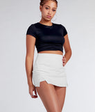 Create bold, fashion-forward looks for spring or summer with the Cute Attitude Ponte Slit Mini Skort in ivory, a must-have piece from Windsor’s collection of stylish bottoms for women.