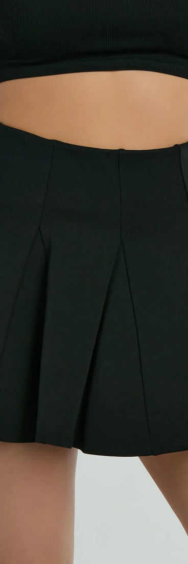 The Flirty Attitude Pleated Knit Skater Skort is a trendy women's bottom in black, designed with modern details and alluring textures to complete chic outfits for 2025.