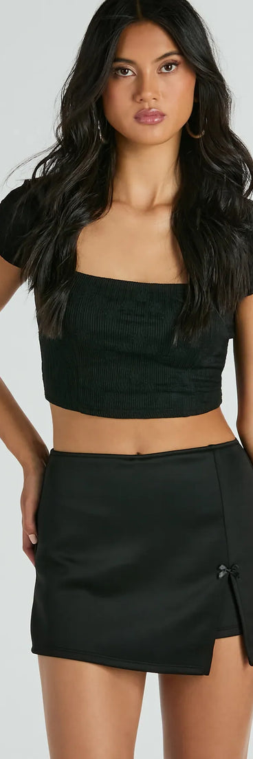 The Significant Strut Mid-Rise Bow Slit Skort is a trendy women's bottom in black, designed with modern details and alluring textures to complete chic outfits for 2025.