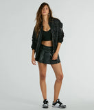 Complete your summer wardrobe with the Feeling Cool Pleated Faux Leather Mini Skort, a trendy skort in black made to mix, match, and stand out.