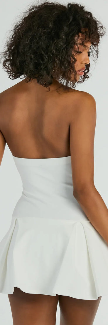 The Sweet Muse Strapless Bow-Detail Skater Romper in ivory combines chic design and festive charm, offering a cocktail dress perfect for winter cocktail parties, work events, and holiday soirées.