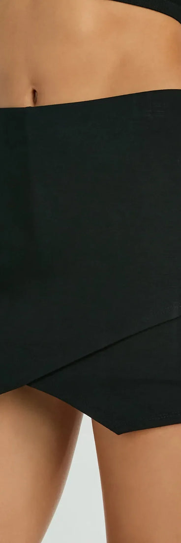 The Always A Sensation High-Rise Ponte Skort in black is a women's workwear piece offering a trendy style and unique accents, perfect for effortlessly creating an outfit-of-the-day look that transitions your office look to going-out ready.