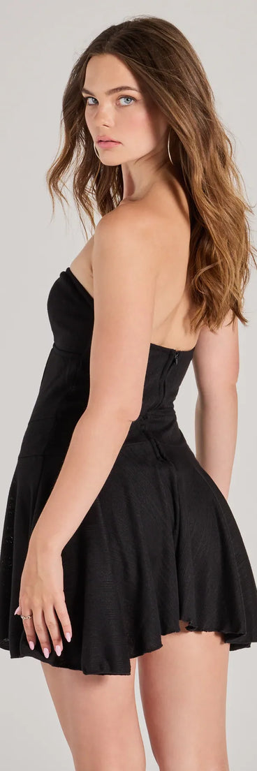 The Sweet Allure Strapless Drop Waist Skater Romper is a trendy women's bottom in black, designed with modern details and alluring textures to complete chic outfits for 2025.