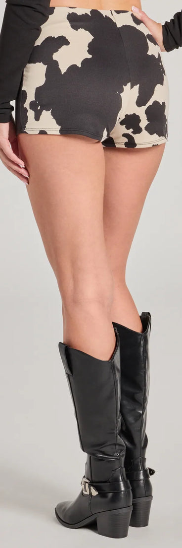 The Cowgirl Outlaw Cow Print Hot Shorts is a trendy women's bottom in black, designed with modern details and alluring textures to complete chic outfits for 2025.