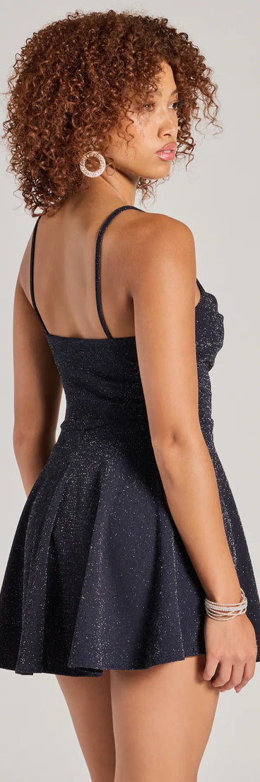 The Take Me Dancing Cowl Neck Skater Glitter Romper is a trendy women's bottom in navy blue, designed with modern details and alluring textures to complete chic outfits for 2025.