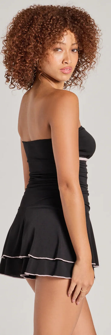 The Little Crush Sleeveless Bow Pleated Romper is a trendy women's bottom in black, designed with modern details and alluring textures to complete chic outfits for 2025.