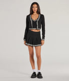 The Preppy Please Striped Pleated Knit Skort is a trendy women's bottom in black, designed with modern details and alluring textures to complete chic outfits for 2025.