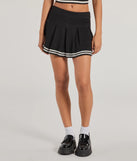 The Preppy Please Striped Pleated Knit Skort is a trendy women's bottom in black, designed with modern details and alluring textures to complete chic outfits for 2025.