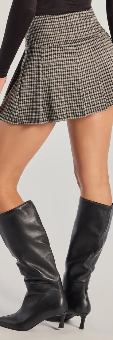 The Preppy Appeal Pleated Plaid Skort is a trendy women's bottom in black, designed with modern details and alluring textures to complete chic outfits for 2025.