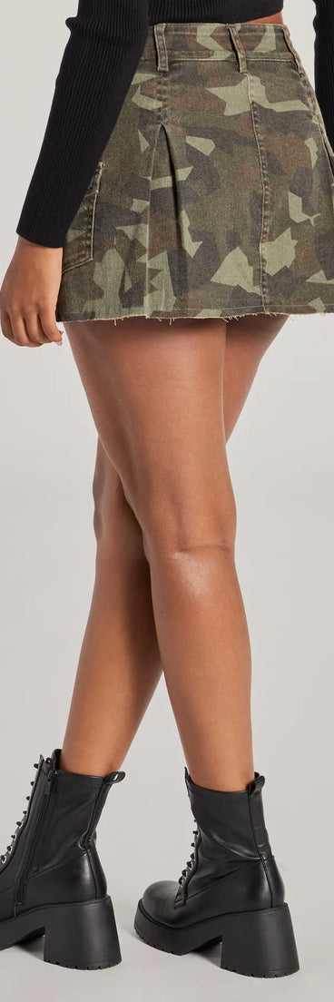The Adventurous Babe Camo Pleated Cargo Mini Skirt is a trendy women's bottom in olive green, designed with modern details and alluring textures to complete chic outfits for 2025.