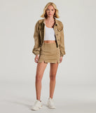 The Trendy Girl High-Rise Slit Denim Skort is a trendy women's bottom in tan, designed with modern details and alluring textures to complete chic outfits for 2025.