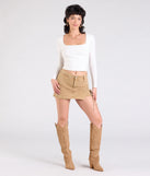 The Take Me Places High-Rise Denim Mini Skort in khaki brings edge and energy to your vibe, ready to elevate any festival look or concert outfit.