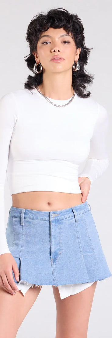 Pair the Talk About Me Mid-Rise Pleated Denim Skort with your favorite crop or bodysuit for effortless fall outfits with on-trend medium denim wash skorts that speak your style.