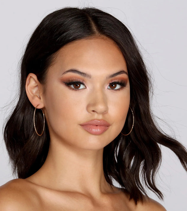 The Tiny & Textured Shimmer Hoops in gold is an elevated pick for your best outfit yet, effortlessly delivering a polished look that's sure to turn heads at any celebration.
