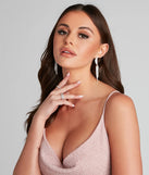 Turn heads at Prom 2025 in this silver prom dress, where statement-making details meet the iconic style of the Twisted Rhinestone Dusters .