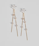 The Graceful Flair Floral Linear Earrings in white brings sleek style to any graduation outfit, from cap and gown to after-party.