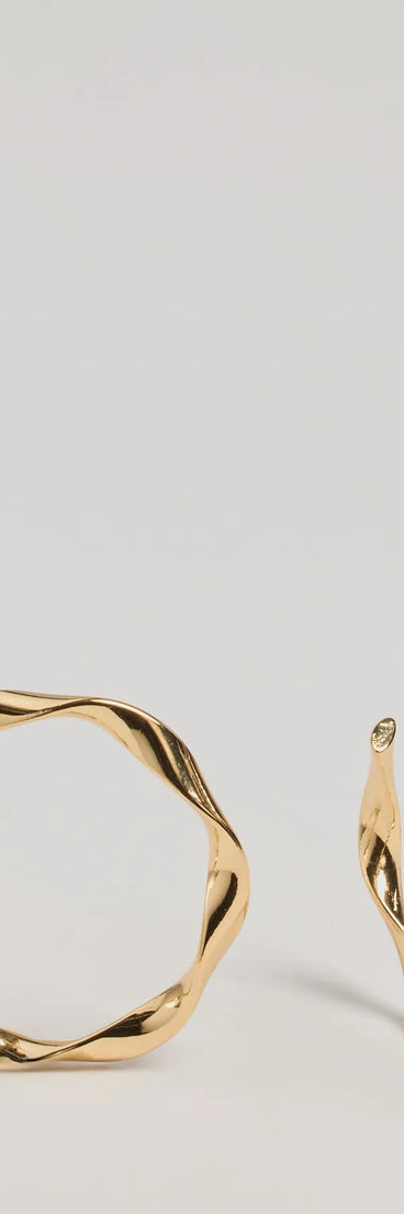 The Stunning Glam Twist Hoop Earrings in gold is a women's workwear essential with an elevated fabric and chic silhouette, ideal for layering and versatile enough to take your look from office chic to going-out ready!
