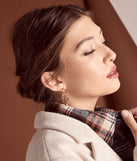 The Stunning Glam Twist Hoop Earrings in gold is a women's workwear piece offering a trendy style and unique accents, perfect for effortlessly creating an outfit-of-the-day look that transitions your office look to going-out ready.