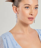 The Radiant Allure Rhinestone Teardrop Linear Earrings helps create a chic silver women's cocktail outfit with a trendy texture and stylish design, ideal for wedding guest cocktail outfits or dinner parties.