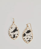 The Country Chic Cow Print Teardrop Earrings in multi-color brings edge and energy to your vibe, ready to elevate any festival look or concert outfit.