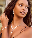 Get ready for any event with the Timeless Elegance Floral Rhinestone and Pearl Necklace Set, an essential start to creating a versatile holiday outfit for women for holiday parties, cocktail hours, or NYE events.