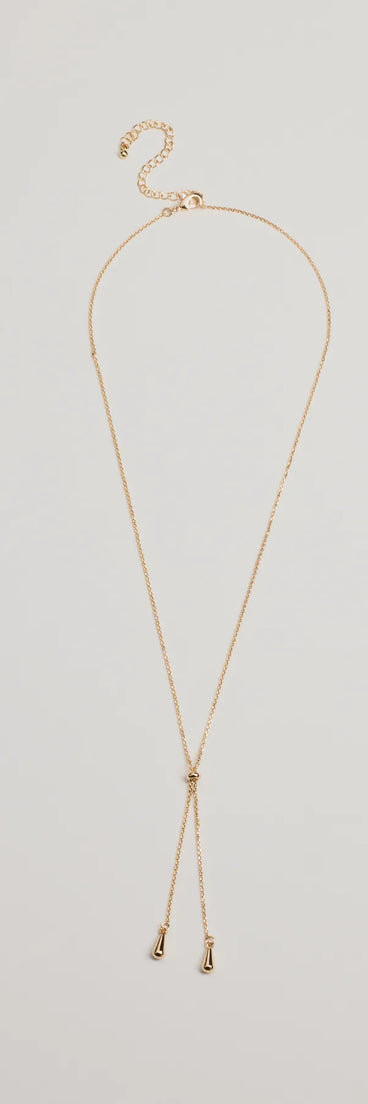 The Sleek Minimalist Era Teardrop Slider Necklace in gold is a women's workwear essential with an elevated fabric and chic silhouette, ideal for layering and versatile enough to take your look from office chic to going-out ready!