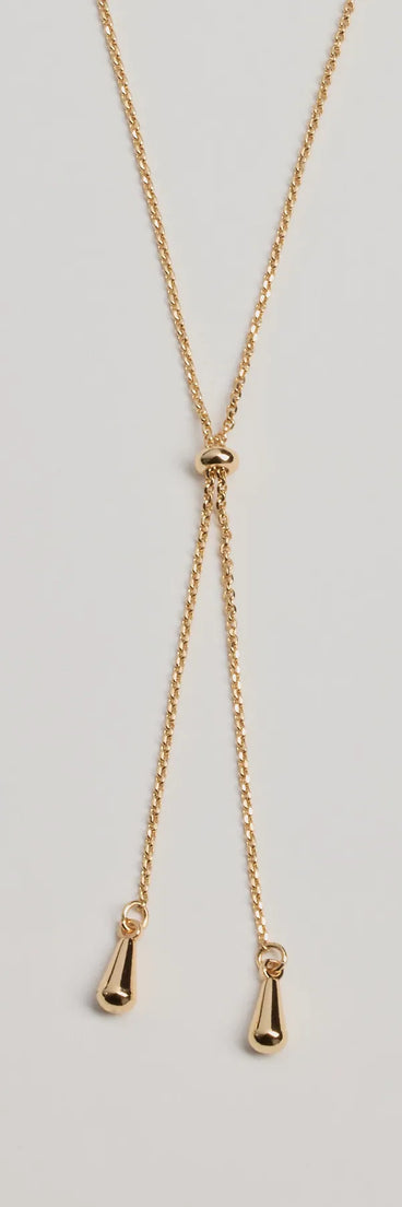 The Sleek Minimalist Era Teardrop Slider Necklace in gold is a women's workwear piece offering a trendy style and unique accents, perfect for effortlessly creating an outfit-of-the-day look that transitions your office look to going-out ready.