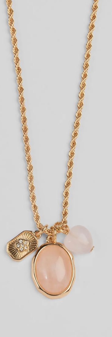 Whether you're dressing up for a romantic date or a Galentine's event, the Boho Chic Rose Quartz Pendant Charm Necklace in gold is the perfect accessory to elevate your Valentine's Day outfit.