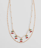 Stay on-trend this season with the Taste So Sweet Cherry And Faux Pearl Layered Necklace in gold, a must-have for creating stylish and effortless spring outfits for women.