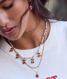 Stay on-trend this season with the Taste So Sweet Cherry And Faux Pearl Layered Necklace in gold, a must-have for creating stylish and effortless spring outfits for women.