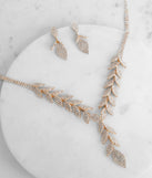 Stay on-trend this season with the Luxe Leaf Lariat And Duster Earrings in gold, a must-have for creating stylish and effortless spring outfits for women.