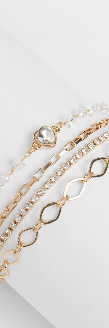 Stay on-trend this season with the Sparkling Addition Heart Charm Layered Bracelet in gold, a must-have for creating stylish and effortless spring outfits for women.