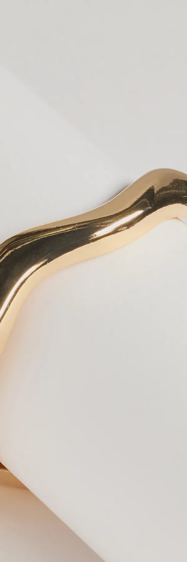 The Classic Twist Wavy Metal Clasp Bracelet in gold is a women's workwear essential with an elevated fabric and chic silhouette, ideal for layering and versatile enough to take your look from office chic to going-out ready!