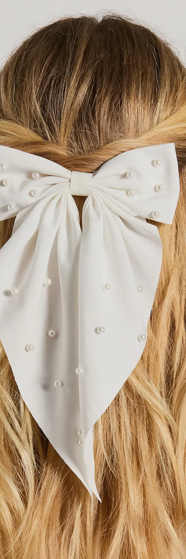 Upgrade your style game for 2025 with the Ravishing And Chic Faux Pearl Hair Bow Barrette in white, perfect for any fashion-forward wardrobe.