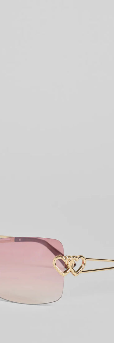 Stole Your Heart Charms Shield Sunglasses, a trendy pink addition to women's going-out outfits, is ideal for Christmas party outfits, chic NYE attire, or winter night-out looks that keep you on-trend!