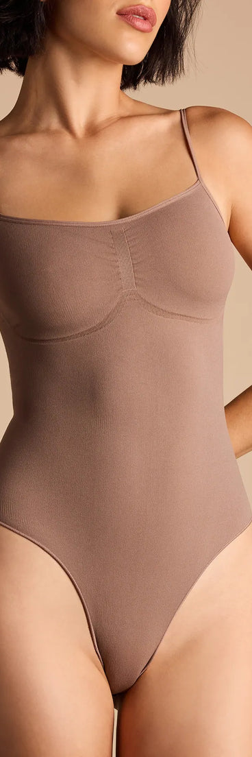 Elevate your winter outfits with the Staple Piece Scoop Neck Bodysuit, a brown bodysuit designed for confident and effortless styling with anything from mini skirts to high-waist jeans.