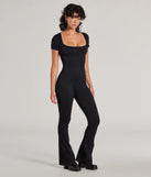 The Stylish Strut Seamless Knit Flared Leg Catsuit in black is a sleek women's catsuit featuring a chic, body-hugging silhouette with on-trend details for a striking profile, perfect for creating going-out looks or party outfits.