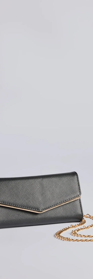 The Classically Chic Faux Leather Envelope Wristlet in black is a women's workwear essential with an elevated fabric and chic silhouette, ideal for layering and versatile enough to take your look from office chic to going-out ready!